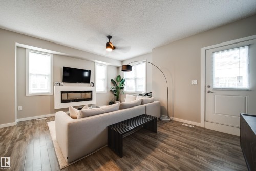 #1 2803 James Mowatt Tr Sw, Edmonton, AB - Indoor Photo Showing Living Room With Fireplace