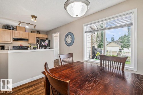 Kitchen with wood-finish flooring, natural wood cabinetry, and track lighting - 4744 Terwillegar Common Nw, Edmonton, AB - Indoor