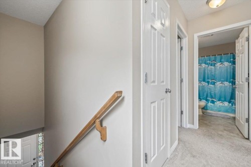 Hallway with light-toned carpeting and flush-mount lighting - 4744 Terwillegar Common Nw, Edmonton, AB - Indoor Photo Showing Other Room