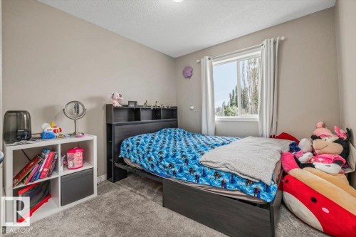 Neutral-toned walls complement the textured gray carpeting - 4744 Terwillegar Common Nw, Edmonton, AB - Indoor Photo Showing Bedroom