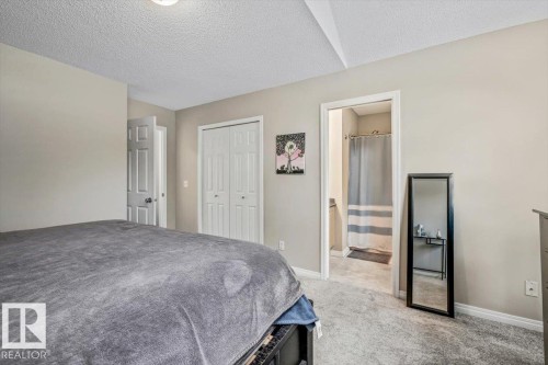 Carpeted flooring, bi-fold closet doors, and light neutral wall paint - 4744 Terwillegar Common Nw, Edmonton, AB - Indoor Photo Showing Bedroom