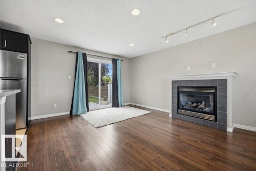 7119 136 Avenue Nw, Edmonton, AB - Indoor Photo Showing Living Room With Fireplace