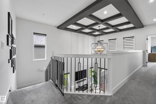 Coffered ceiling with recessed lighting and a geometric chandelier - 7314 Morgan Road Nw, Edmonton, AB - Indoor Photo Showing Other Room