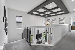 Coffered ceiling with recessed lighting and a geometric chandelier - 