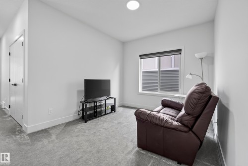 Recessed ceiling lighting, a window with blinds, and white interior doors with black hardware - 7314 Morgan Road Nw, Edmonton, AB - Indoor