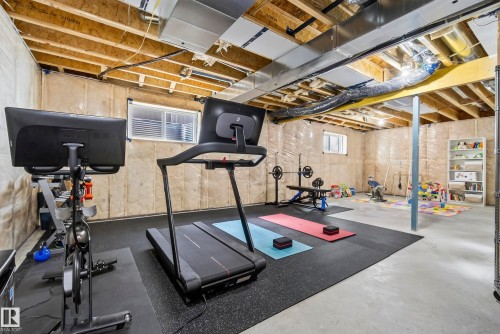Unfinished basement with exposed ceiling joists and ductwork, concrete flooring, and insulated walls - 7314 Morgan Road Nw, Edmonton, AB - Indoor Photo Showing Gym Room