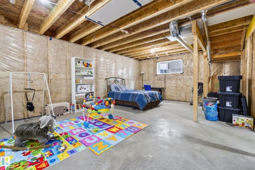 Unfinished basement with exposed ceiling joists and concrete flooring - 7314 Morgan Road Nw, Edmonton, AB - Indoor Photo Showing Basement