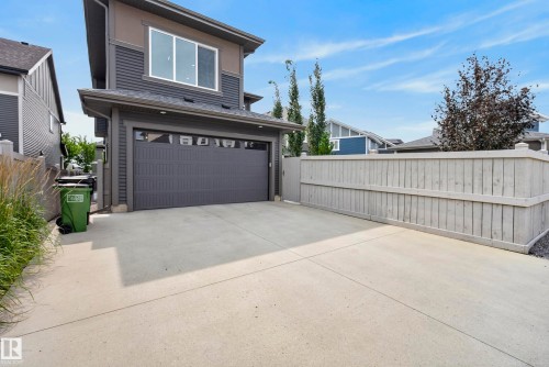 Two-story exterior with horizontal siding and an attached garage - 7314 Morgan Road Nw, Edmonton, AB - Outdoor With Exterior