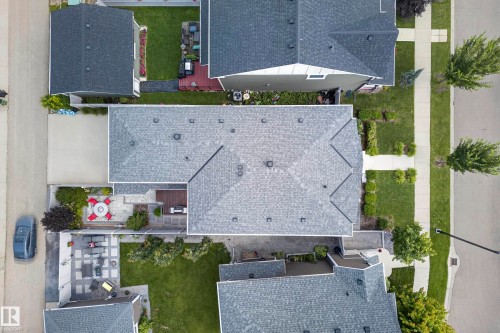 Asphalt shingle roofing, paved driveway, concrete walkway, landscaped front yard, and a patio area - 7314 Morgan Road Nw, Edmonton, AB - Outdoor