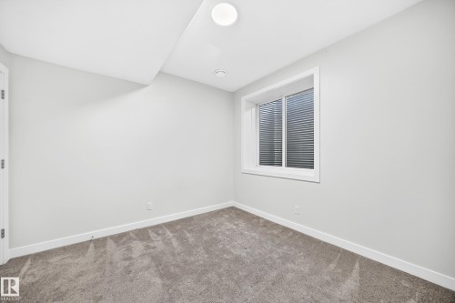 Recessed lighting, wall-to-wall carpeting, and a window with horizontal blinds - 3816 Chrustawka Place Sw, Edmonton, AB - Indoor Photo Showing Other Room