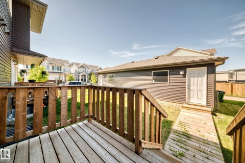 Wood-finish deck with railings, wood-finish ramp, and separate building with a four-panel door - 3816 Chrustawka Place Sw, Edmonton, AB - Outdoor With Deck Patio Veranda With Exterior