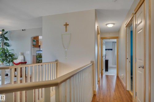 Upper-level hallway with wood-finish flooring, white walls, and light wood trim - 4224 53 Ave, Wetaskiwin, AB - Indoor Photo Showing Other Room