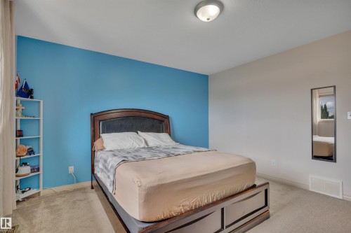Recessed lighting fixture, light-colored carpeting, and a contrasting accent wall - 4224 53 Ave, Wetaskiwin, AB - Indoor Photo Showing Bedroom