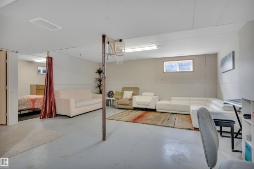 Finished basement space with painted concrete flooring, recessed lighting, and a small egress window - 4224 53 Ave, Wetaskiwin, AB - Indoor Photo Showing Basement