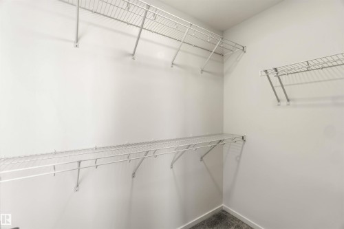 Walk-in closet featuring white wire shelving, white walls, and gray carpeting - 265 Chappelle Drive Sw, Edmonton, AB - Indoor With Storage