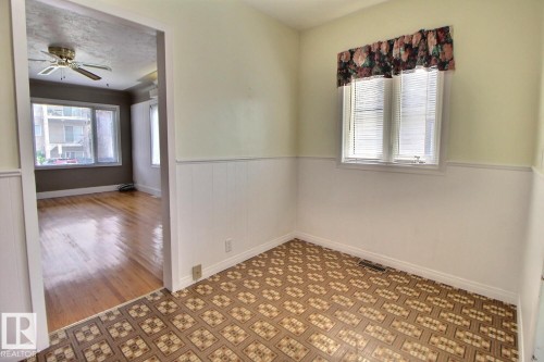Wood-finish flooring, patterned floor tiles, overhead ceiling fan, and window with blinds - 11336 83 Street Nw, Edmonton, AB - Indoor Photo Showing Other Room
