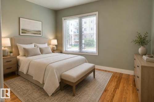 Hardwood flooring, generously sized window with blinds, light green wall finishes, and white trim molding - 11336 83 Street Nw, Edmonton, AB - Indoor Photo Showing Bedroom