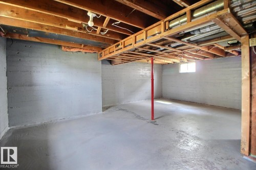 Unfinished basement with exposed ceiling joists, concrete walls, and a concrete floor - 11336 83 Street Nw, Edmonton, AB - Indoor Photo Showing Basement