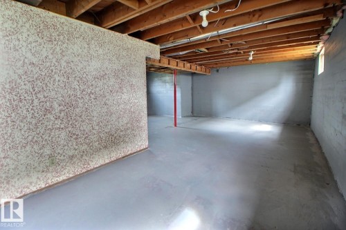 Unfinished basement space with exposed wood joists and concrete flooring - 11336 83 Street Nw, Edmonton, AB - Indoor Photo Showing Basement