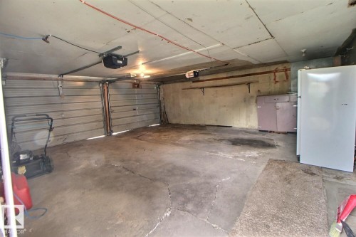 Attached garage with dual overhead doors - 11336 83 Street Nw, Edmonton, AB - Indoor Photo Showing Garage