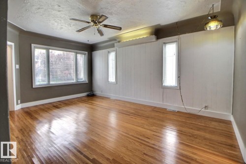 Hardwood flooring, multi-pane window, ceiling fan, wainscoting, and recessed window - 11336 83 Street Nw, Edmonton, AB - Indoor Photo Showing Other Room