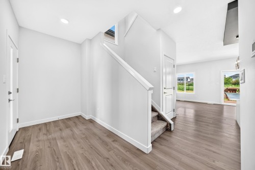Wood-finish flooring throughout, bright white walls, and recessed lighting - 8823 Carson Way Sw, Edmonton, AB - Indoor Photo Showing Other Room