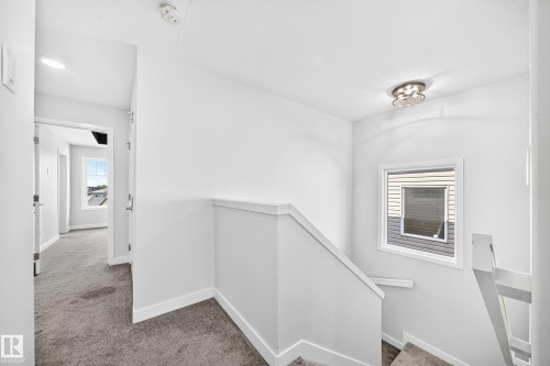 Hallway featuring recessed lighting, a window, and carpet flooring - 8823 Carson Way Sw, Edmonton, AB - Indoor Photo Showing Other Room