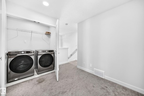 Integrated laundry closet with wire shelving - 8823 Carson Way Sw, Edmonton, AB - Indoor Photo Showing Laundry Room