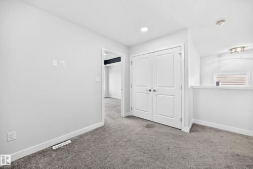 Neutral wall paint, gray carpet, white trim, recessed lighting, and a flush-mount light fixture - 8823 Carson Way Sw, Edmonton, AB - Indoor Photo Showing Other Room