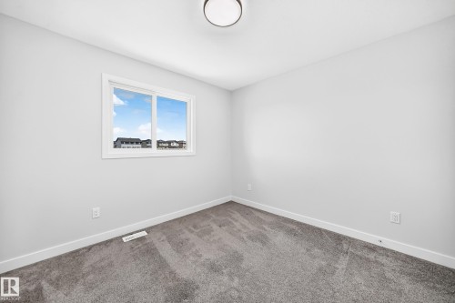 Neutral wall paint with a window and gray carpet flooring - 8823 Carson Way Sw, Edmonton, AB - Indoor Photo Showing Other Room