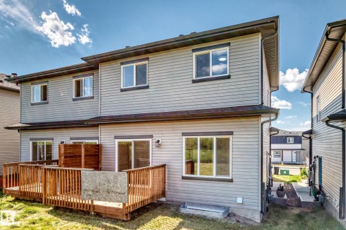 Gray horizontal siding exterior with a multi-level wood deck - 8823 Carson Way Sw, Edmonton, AB - Outdoor With Exterior