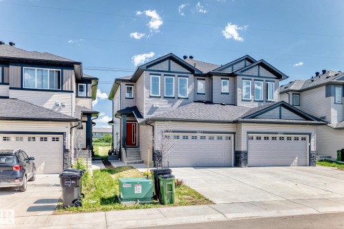 Modern exterior with gray siding, dark trim accents, multiple gables, and an attached two-car garage - 8823 Carson Way Sw, Edmonton, AB - Outdoor With Facade