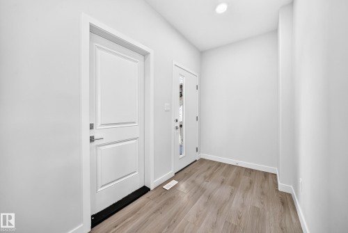 Wood-finish flooring and white walls - 8823 Carson Way Sw, Edmonton, AB - Indoor Photo Showing Other Room