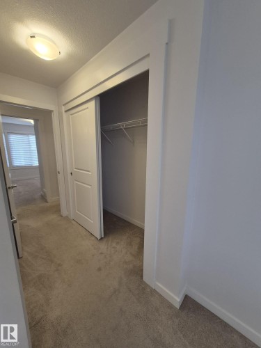 Recessed closet featuring sliding doors and wire shelving - Edmonton, AB - Indoor Photo Showing Other Room