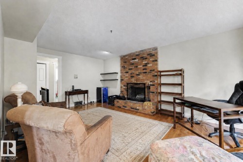 11233 34A Avenue Nw, Edmonton, AB - Indoor Photo Showing Living Room With Fireplace