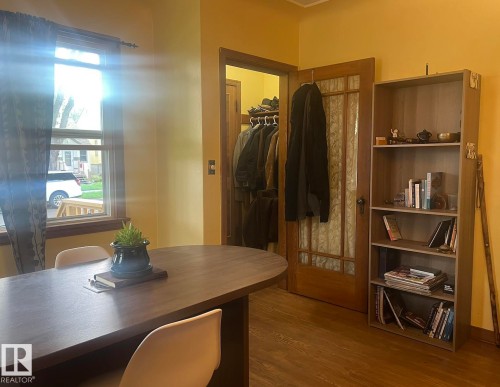 Wood-finish flooring with a wood-frame window - 9828 84 Avenue Nw, Edmonton, AB - Indoor