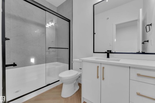 White vanity with gold-tone hardware, rectangular undermount sink, and black wall-mounted faucet - 465 Crystal Creek Link, Leduc, AB - Indoor Photo Showing Bathroom