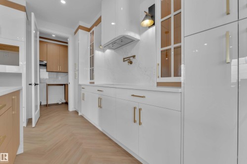 White high-gloss cabinetry with gold-tone hardware - 465 Crystal Creek Link, Leduc, AB - Indoor Photo Showing Other Room