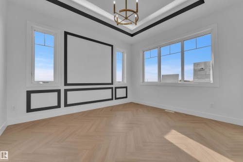 Tray ceiling with black trim, recessed lighting, and a chandelier - 465 Crystal Creek Link, Leduc, AB - Indoor Photo Showing Other Room