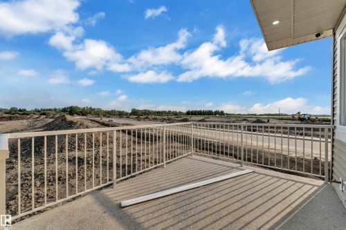 Concrete balcony with a white metal railing, recessed lighting, and siding exterior - 465 Crystal Creek Link, Leduc, AB - Outdoor With View