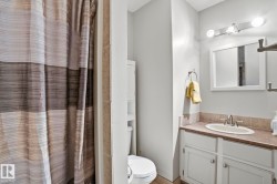 Bathroom featuring a white framed mirror, vanity with an integrated sink, built-in medicine cabinet, and overhead light fixture - 
