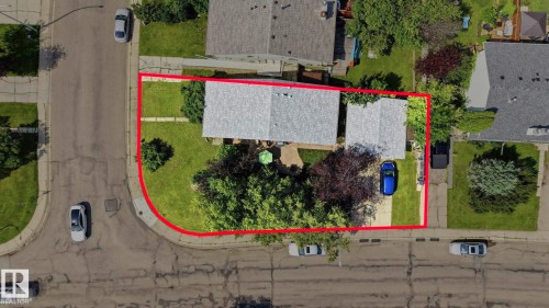 Corner lot property featuring a single-story residence with a gray shingled roof - 5702 52 Avenue, Beaumont, AB - Outdoor