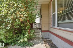Covered porch entry featuring concrete steps, siding exterior, and a prominent window with blinds - 