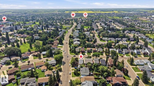 Aerial perspective showcasing a residential neighborhood with extensive tree coverage and established streets - 5702 52 Avenue, Beaumont, AB - Outdoor With View