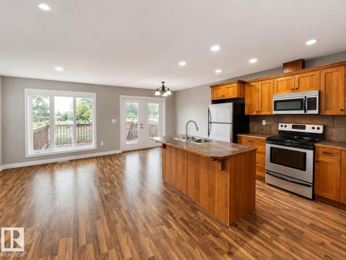 27 Deer Coulee Drive, Didsbury, AB - Indoor Photo Showing Kitchen With Double Sink