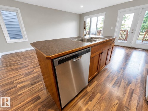 27 Deer Coulee Drive, Didsbury, AB - Indoor Photo Showing Kitchen With Double Sink