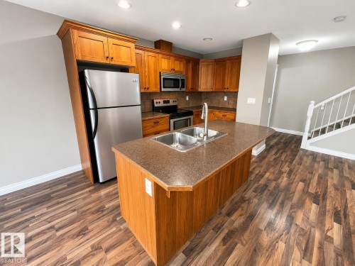 27 Deer Coulee Drive, Didsbury, AB - Indoor Photo Showing Kitchen With Stainless Steel Kitchen With Double Sink