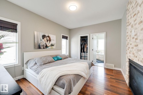 876 Hodgins Road Nw, Edmonton, AB - Indoor Photo Showing Bedroom With Fireplace