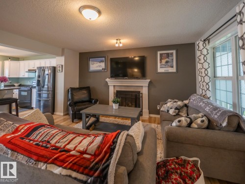 12124 17 Avenue Sw, Edmonton, AB - Indoor Photo Showing Living Room With Fireplace