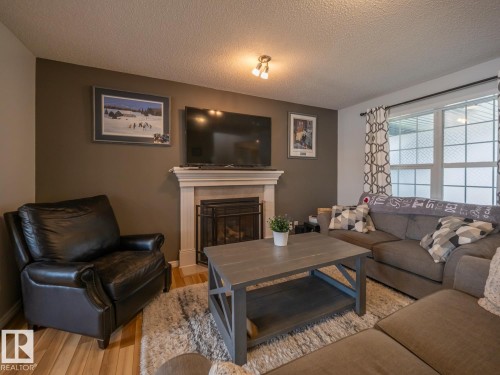 12124 17 Avenue Sw, Edmonton, AB - Indoor Photo Showing Living Room With Fireplace